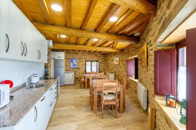 a kitchen and dining room with a table and chairs at Casa Añolo in Sober