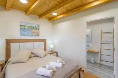 a bedroom with a bed with towels on it at Casa Añolo in Sober