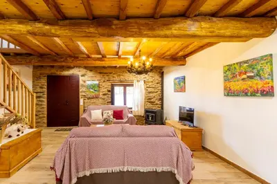 a living room with a bed and a tv at Casa Añolo in Sober