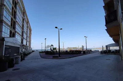 an empty street next to a building with a street light at Apartamento en Foz. Primera Línea Playa Rapadoira in Foz