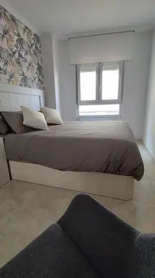 a bedroom with a large bed with a window at Apartamento en Foz. Primera Línea Playa Rapadoira in Foz