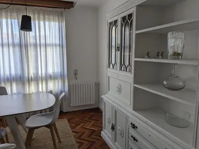 a dining room with a table and a white cabinet at Mirador de Ferradores in Betanzos
