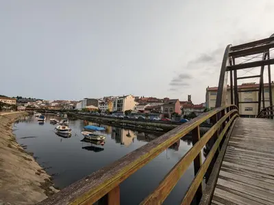 a bridge over a river with boats in the water at Mirador de Ferradores in Betanzos