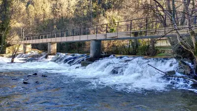 a bridge over a river with water rushing under it at Mirador de Ferradores in Betanzos