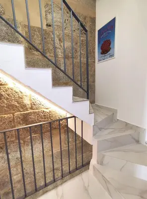 a staircase in a house with a painting on the wall at Cánovas 21 in Carballino