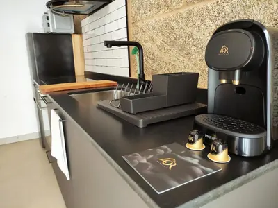 a kitchen counter with a coffee maker on it at Cánovas 21 in Carballino
