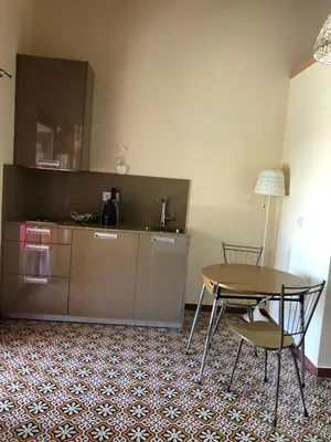 a kitchen with a table and a table and chairs at Pension Gabino (rooms) in El Ganso