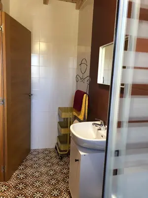 a bathroom with a sink and a mirror at Pension Gabino (rooms) in El Ganso