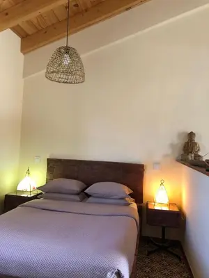 a bedroom with a bed with two lamps on it at Pension Gabino (rooms) in El Ganso