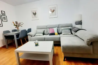a living room with a couch and a table at Apartamento Obao in Ribadeo