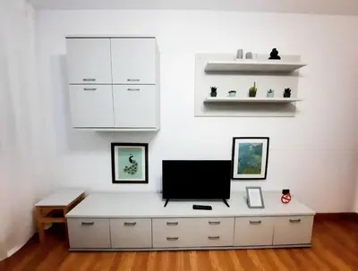 a white room with a desk with a tv on it at Apartamento Obao in Ribadeo