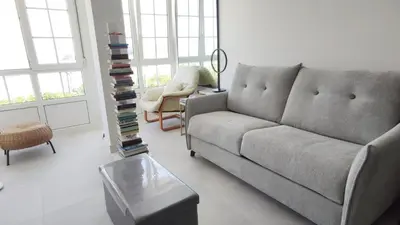 a living room with a couch and a table at Suite Playa in Miño