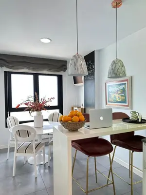 a kitchen with a table with a laptop on it at DÚPLEX DE LUJO EN FOZ CON VISTAS al MAR in Foz