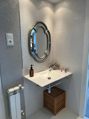 a bathroom with a sink and a mirror on the wall at DÚPLEX DE LUJO EN FOZ CON VISTAS al MAR in Foz