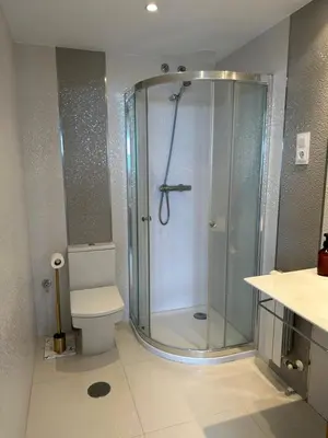 a bathroom with a shower and a toilet at DÚPLEX DE LUJO EN FOZ CON VISTAS al MAR in Foz