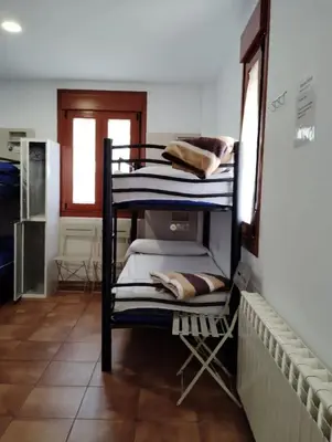 a group of bunk beds in a room at Albergue Miraiso in Arzúa