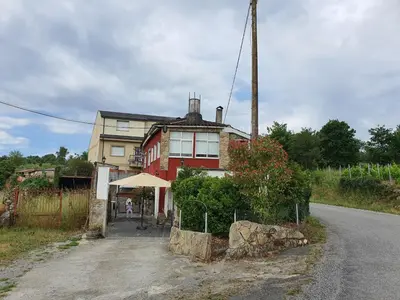 a house sitting on the side of a road at Casa Manuel in Toldaos