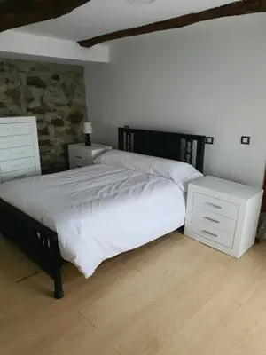 a bedroom with a white bed and a white dresser at Casa Manuel in Toldaos