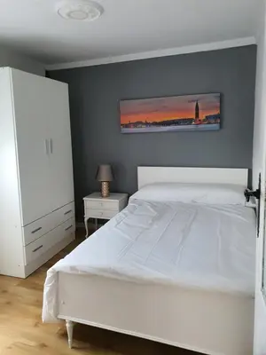 a bed in a room with white sheets on it at Casa Manuel in Toldaos