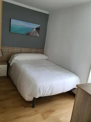 a bed in a bedroom with a painting on the wall at Casa Manuel in Toldaos