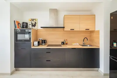 a kitchen with a sink and a stove top oven at Iria Gardens in Padrón