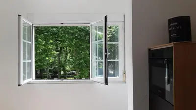 a window in a room with a view of a tree at Iria Gardens in Padrón