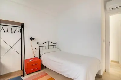 a bedroom with a white bed and a red dresser at Iria Gardens in Padrón