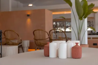 a group of white candles sitting on a table at Malates Slow Boutique Hotel in Foz