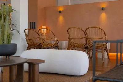 a group of chairs and a table and a couch at Malates Slow Boutique Hotel in Foz