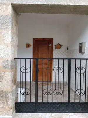 a wrought iron fence in front of a door at VIVEIRO.CELEIRO. CASA TRANQUILA. RESURRECTION FEST in Cillero