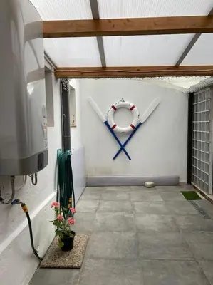 a room with a wall with a life preserver on it at VIVEIRO.CELEIRO. CASA TRANQUILA. RESURRECTION FEST in Cillero