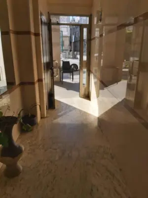 an empty hallway with glass doors in a building at Piso Alameda Carballiño in Carballino