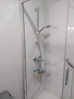 a bathroom with a shower with a glass door at Piso Alameda Carballiño in Carballino