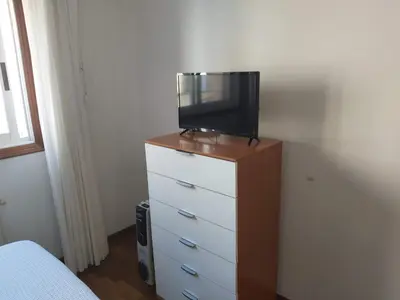 a tv on top of a dresser in a bedroom at Piso Alameda Carballiño in Carballino