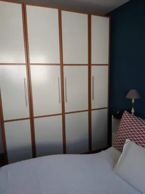 a bedroom with a large closet with white cabinets at Piso Alameda Carballiño in Carballino