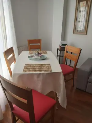a dining room table with a plate of food on it at Piso Alameda Carballiño in Carballino