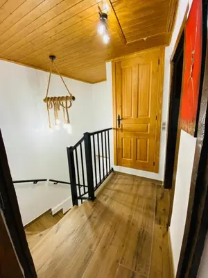 a hallway with a wooden door and a wooden floor at Casa Neto Goje in San Tirso de Abres