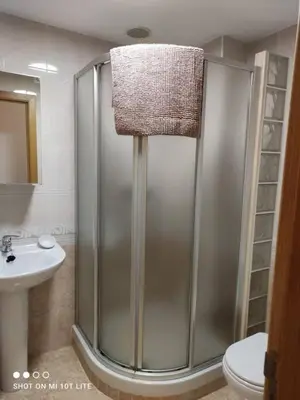 a shower in a bathroom with a toilet and a sink at Precioso apartamento, Pontedeume in Puentedeume