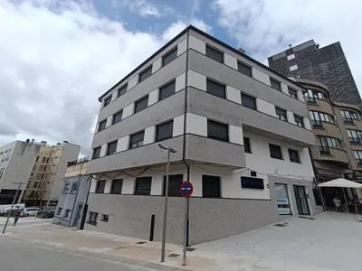a tall building on the corner of a street at Apartamentos Turísticos Pontepedriña by Bossh! Hotels in Santiago de Compostela