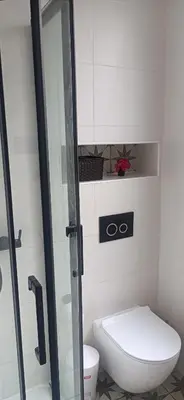 a bathroom with a toilet and a glass shower stall at TraviesaBetanzos in Betanzos