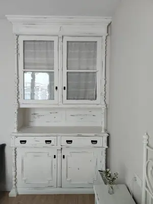 a white cabinet with two windows in a room at TraviesaBetanzos in Betanzos