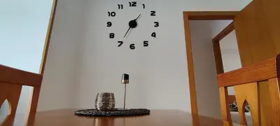 a large clock on a wall in a room at Alojamientos Viveiro - Playa de Covas II in Viveiro
