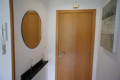 a room with a wooden door and a mirror at Alojamientos Viveiro - Playa de Covas II in Viveiro