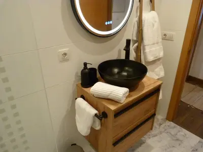 a bathroom with a black sink and a mirror at Apartamento foroplaza campo I in Lugo