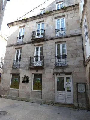a stone building with windows and balconies on a street at Apartamento foroplaza campo I in Lugo
