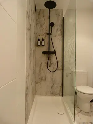 a bathroom with a shower with a toilet and a sink at Apartamento foroplaza campo I in Lugo
