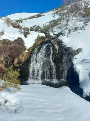a waterfall in the snow on a mountain at VUT Corea324 in Caboalles de Abajo