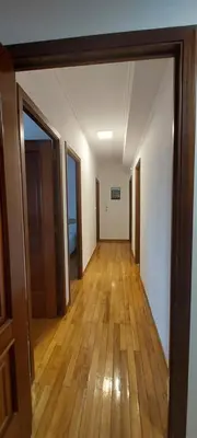 an empty hallway with wooden floors and doors at Piso Ribeira Sacra in Monforte de Lemos