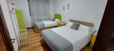 a hotel room with two beds and a hallway at Piso Ribeira Sacra in Monforte de Lemos