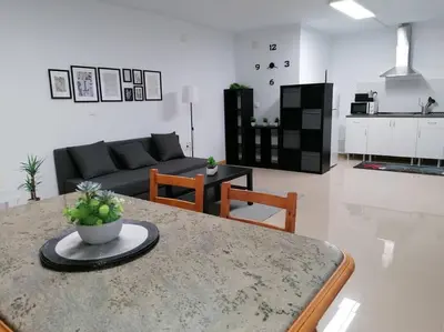 a living room with a couch and a table in a room at Lar de Yago - Apto Ribadeo in Ribadeo